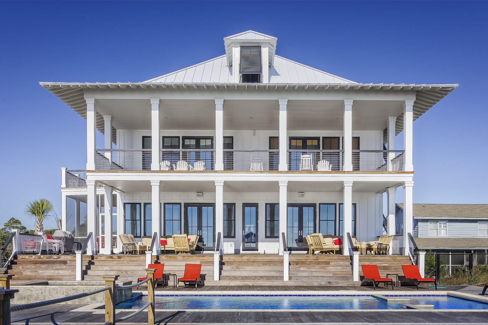 Luxury Viera Florida home with warm evening light, covered lanai, pool, and refined indoor outdoor living