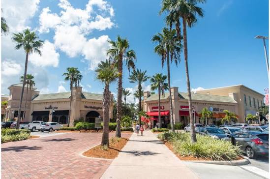 Palm-lined pedestrian shopping walkway at The Avenue Viera